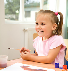 Image showing Little girl is play with paints