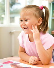 Image showing Little girl is play with paints