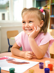 Image showing Little girl is play with paints