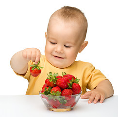 Image showing Happy little boy with strawberries