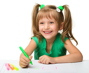 Image showing Cute little girl draws with markers