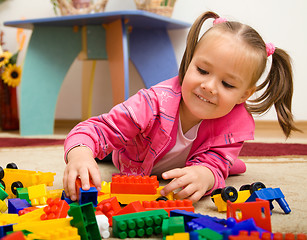 Image showing Little girl is playing with toys in preschool