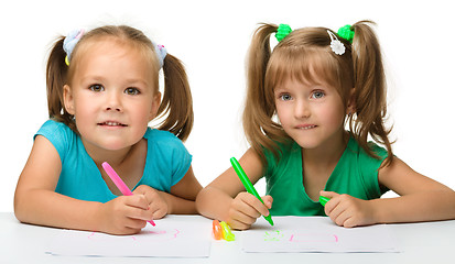 Image showing Two little girls draw with markers