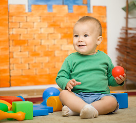 Image showing Little boy is playing with toys in preschool