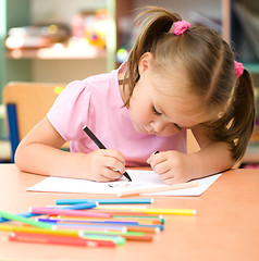 Image showing Little girl is drawing with felt-tip pen