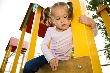 Image showing Little girl is playing in playground