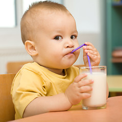 Image showing Little boy is drinking milk