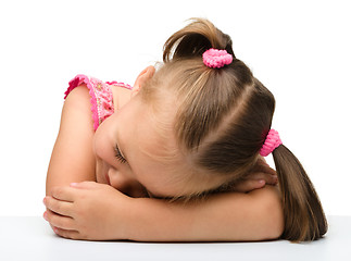 Image showing Little girl is sleeping at table