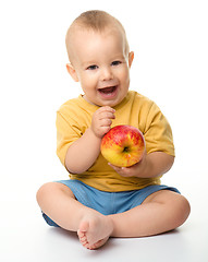 Image showing Cheerful little boy with red apple