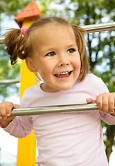 Image showing Little girl is playing in playground