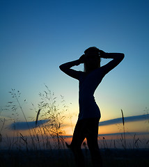 Image showing Silhouette of a girl over sunset