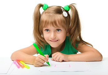 Image showing Cute little girl draws with markers