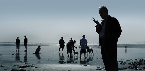 Image showing Dogs and people at the beach