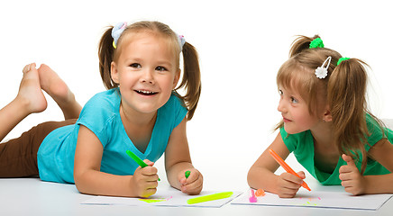 Image showing Two little girls draw with markers