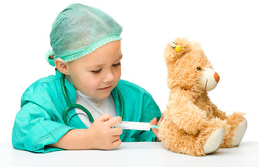 Image showing Little girl is playing doctor with syringe