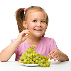 Image showing Little girl is eating grapes