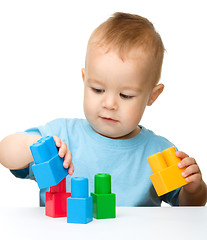 Image showing Little boy plays with building bricks