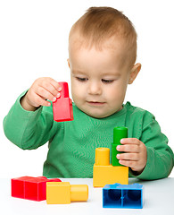 Image showing Little boy plays with building bricks