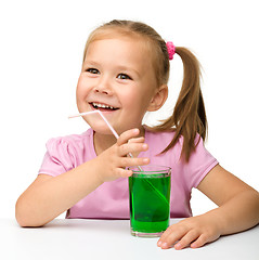 Image showing Little girl with a glass of tarragon drink