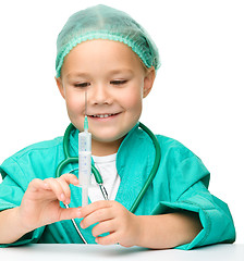 Image showing Little girl is playing doctor with syringe