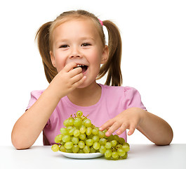 Image showing Little girl is eating grapes