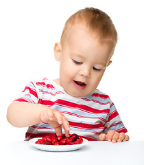 Image showing Cute little boy with strawberries