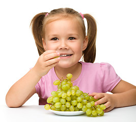 Image showing Little girl is eating grapes