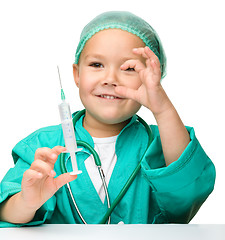 Image showing Little girl is playing doctor with syringe