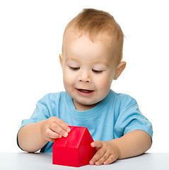Image showing Little boy plays with building bricks