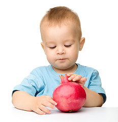 Image showing Little boy with pomegranate