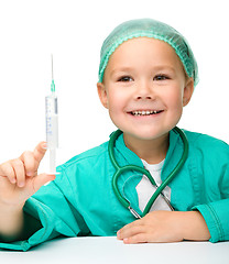 Image showing Little girl is playing doctor with syringe