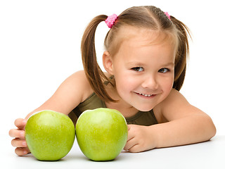 Image showing Little girl with two green apples