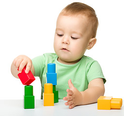 Image showing Little boy plays with building bricks