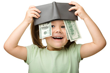 Image showing Cute little girl plays with money