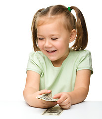 Image showing Cute little girl with paper money - dollars