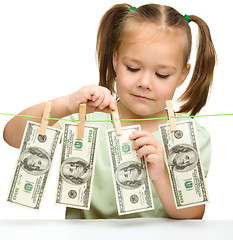 Image showing Cute little girl with paper money - dollars