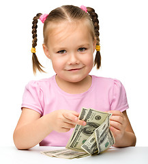 Image showing Cute little girl with paper money - dollars