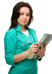 Image showing Young attractive woman wearing a doctor uniform