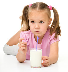 Image showing Little girl drinks milk