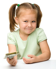 Image showing Cute little girl with paper money - dollars