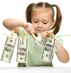 Image showing Cute little girl with paper money - dollars