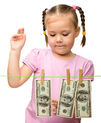 Image showing Cute little girl with paper money - dollars