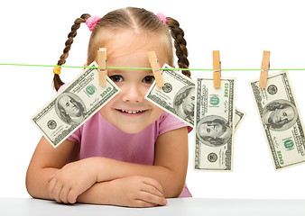 Image showing Cute little girl with paper money - dollars