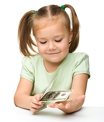 Image showing Cute little girl with paper money - dollars