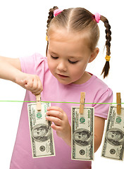 Image showing Cute little girl with paper money - dollars