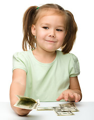 Image showing Cute little girl with paper money - dollars