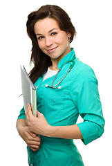 Image showing Young attractive woman wearing a doctor uniform