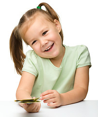 Image showing Cute little girl with paper money - dollars