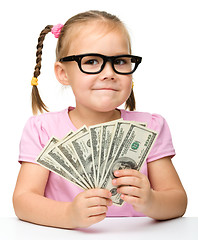 Image showing Cute little girl with paper money - dollars