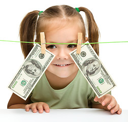 Image showing Cute little girl with paper money - dollars